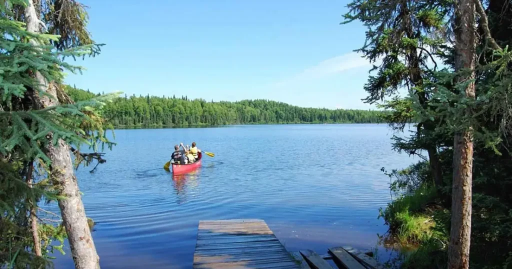 Family canoeing on a lake — illustrative activity for an all inclusive family vacation east coast.