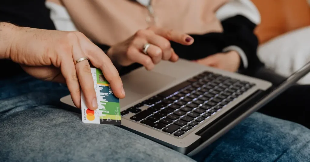 Couple using a laptop and credit card for an online payment