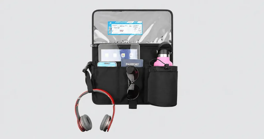 Flight essentials organized in a small travel pouch with headphones and accessories