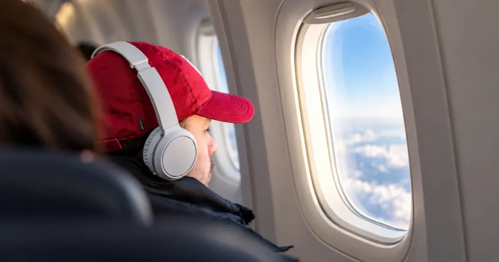 Long haul flight essentials including headphones for a comfortable flight