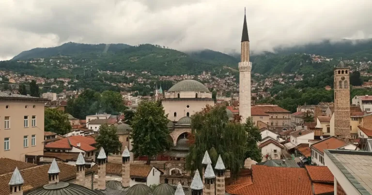 A traveler exploring a scenic old town while traveling the balkans on a $600 budget.